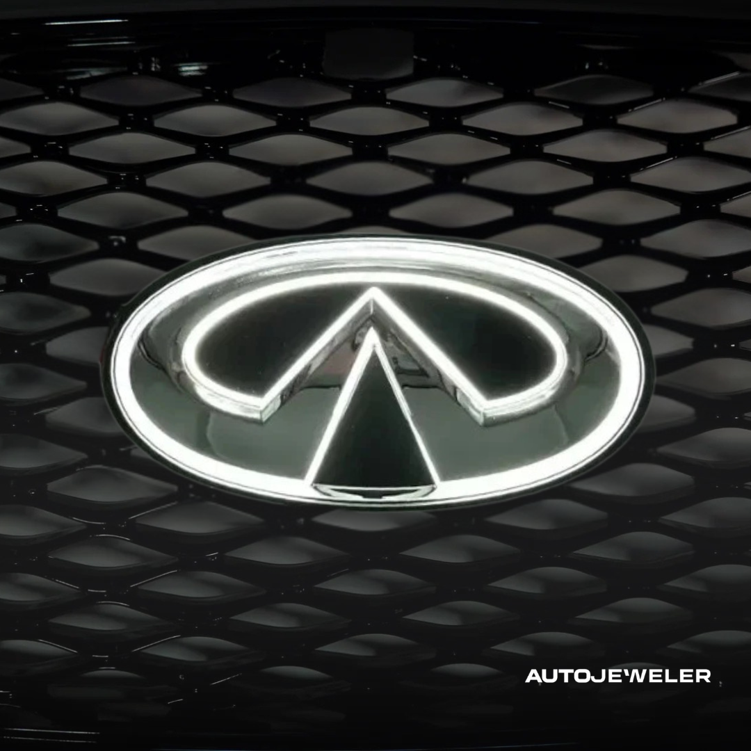Infiniti Q50 illuminated front grille emblem glowing white at night
