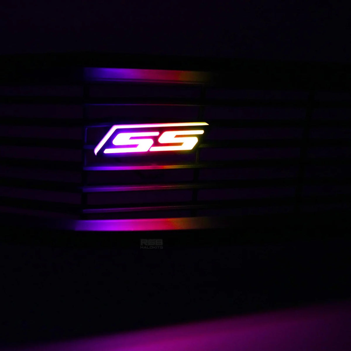 Chevy Camaro SS RGB Flow Series LED grille emblem showing multicolor flowing animation close-up at night