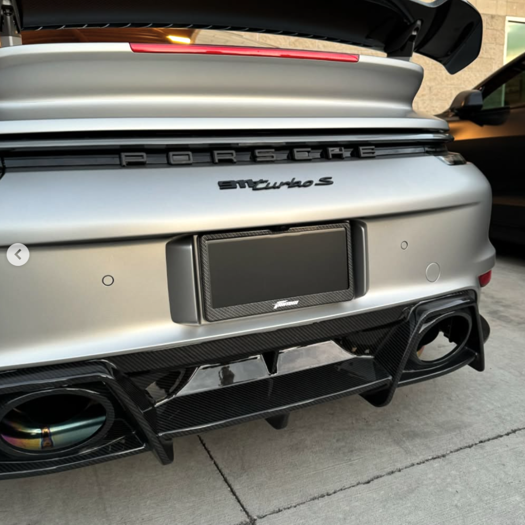 FantomTec blackout privacy plate with carbon fiber frame installed on a rear bumper.