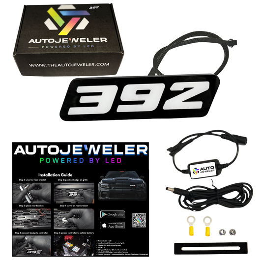 AutoJeweler 392 LED grille emblem kit with Bluetooth controller, wiring harness, hardware, install guide, and branded box on white background.