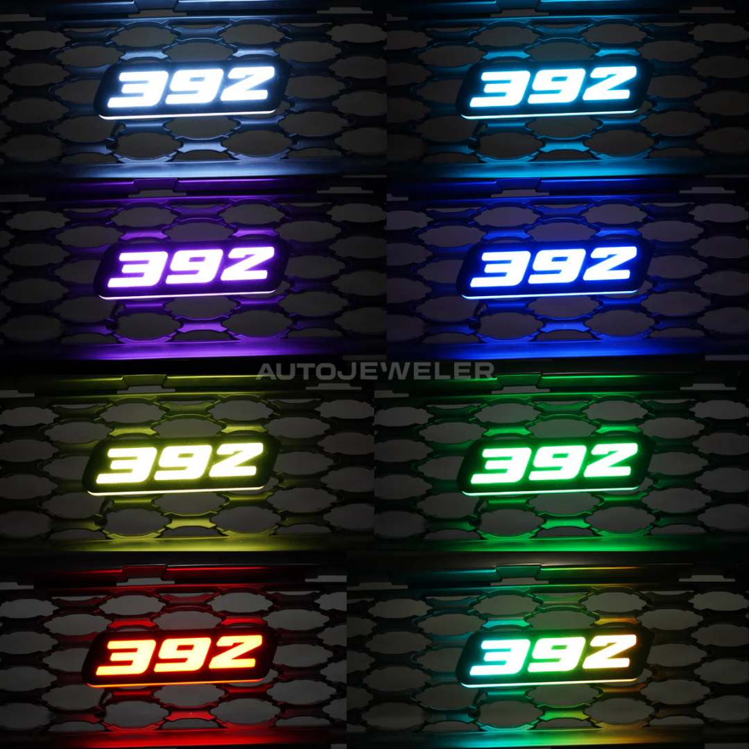 Colorful '392' grille emblem logo on a textured background with 'AUTOJE'WELER' branding.