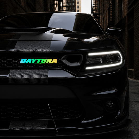 Daytona RGB Flow Series LED grille emblem installed on black Dodge Charger with illuminated multicolor lighting