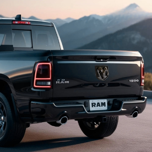 Daytime rear view of RAM truck showing installed AutoJeweler black LED tailgate emblem, unlit.