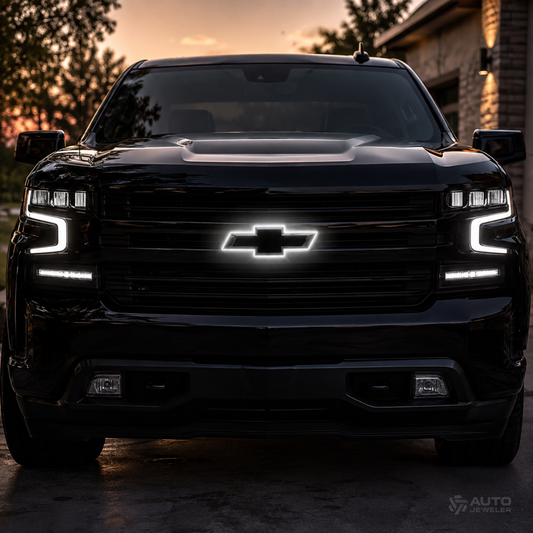 Front view of a black Chevrolet Silverado with a pure white back-lit halo bowtie installed in the grille.