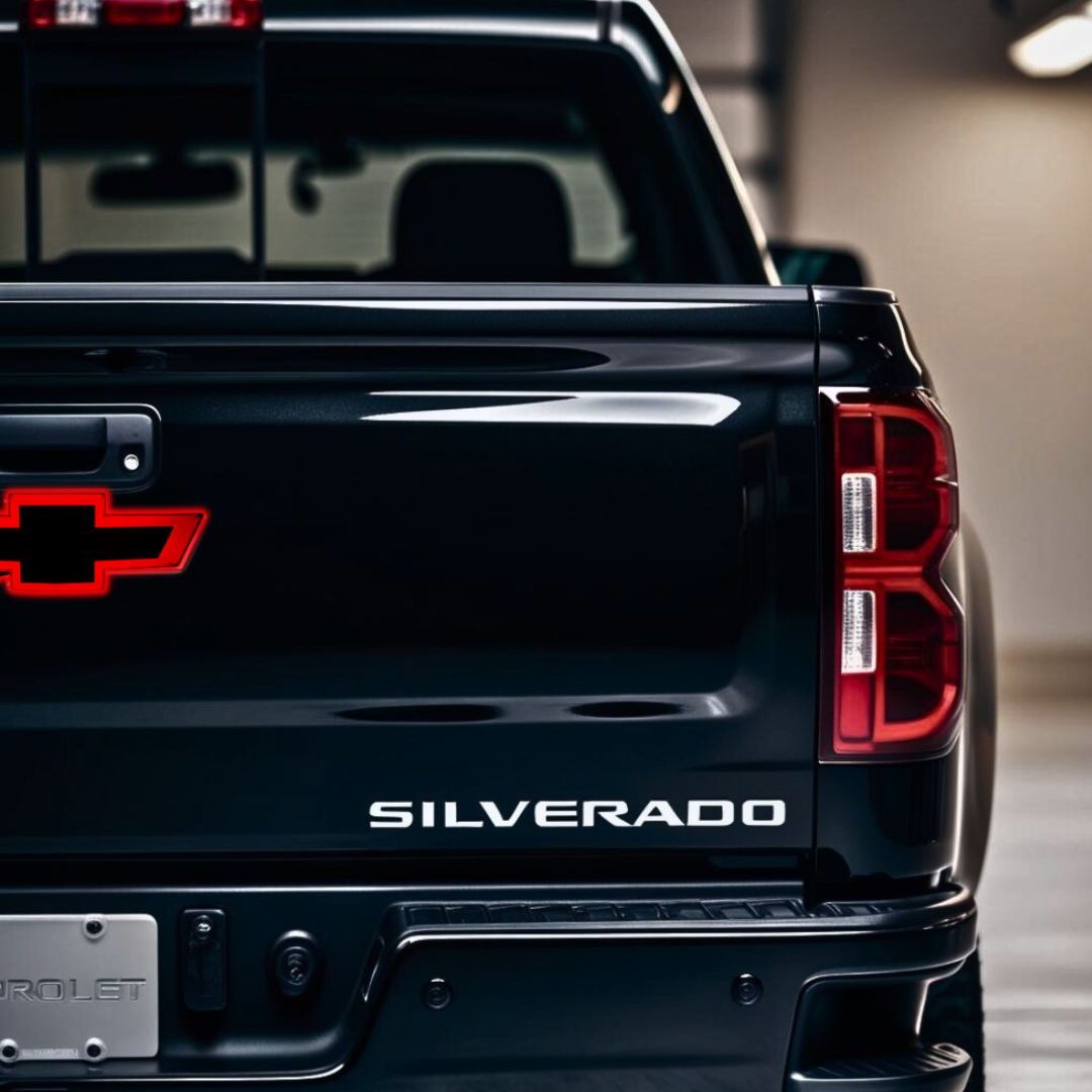 Lifestyle studio shot of Chevy Silverado tailgate with red LED bowtie installed near handle.