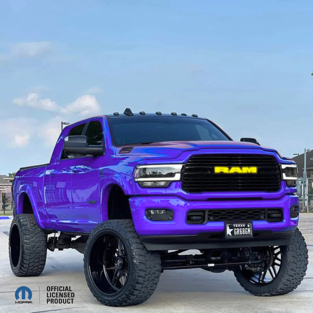 2019–2023 RAM 1500 with black RGB LED grille emblem, illuminated yellow RAM letters, Mopar Official Licensed Product, color-changing LED truck emblem installed on custom RAM 1500