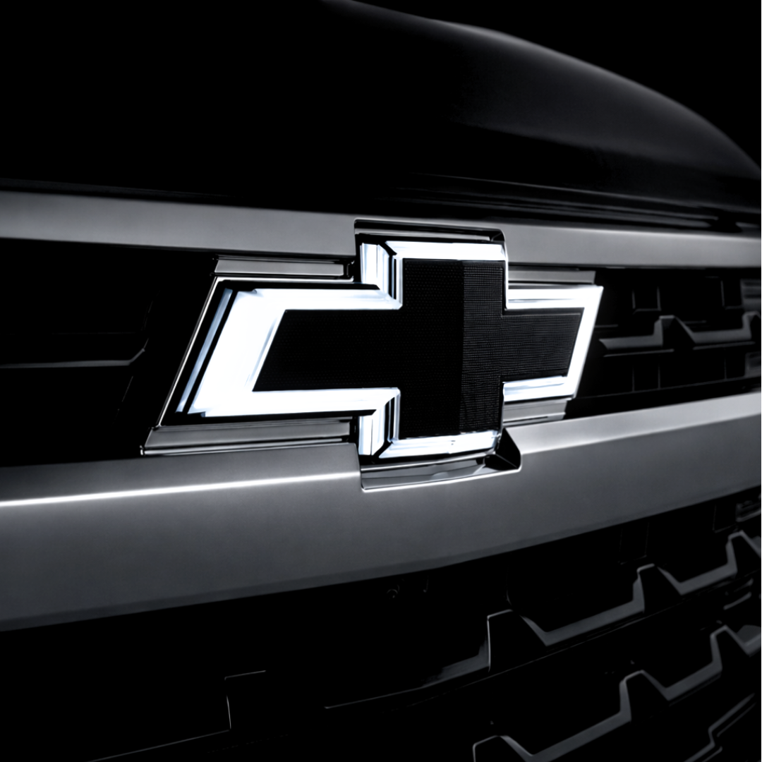 Chevrolet logo on a car grille with a dark background
