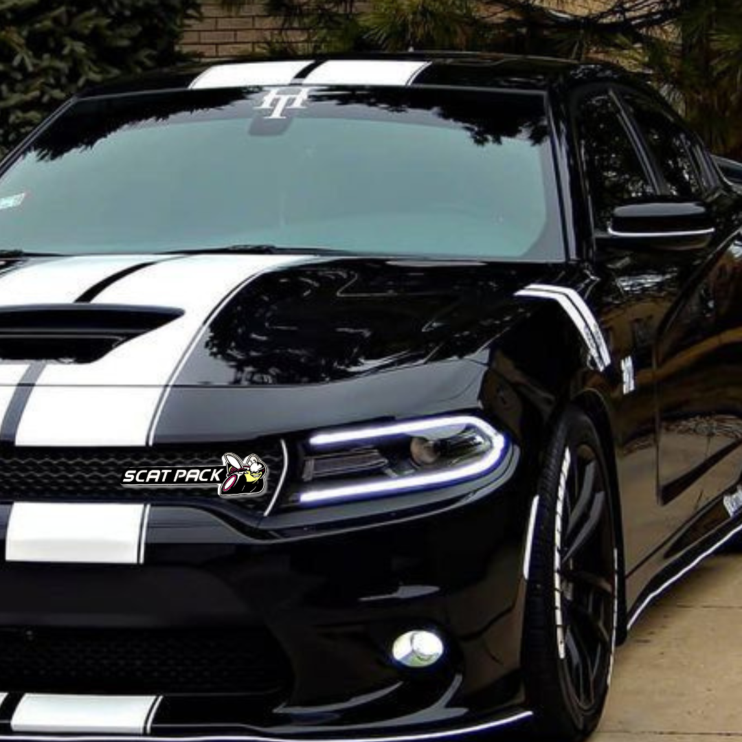 Black and white car with LED Scat Pack grille emblem parked in driveway