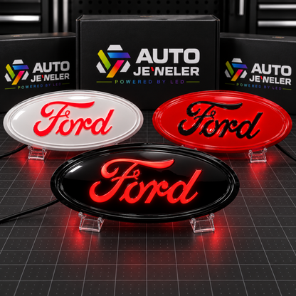 Custom painted Ford 9-inch LED grille and tailgate emblems in white, red, and gloss black, all illuminated with red LEDs.