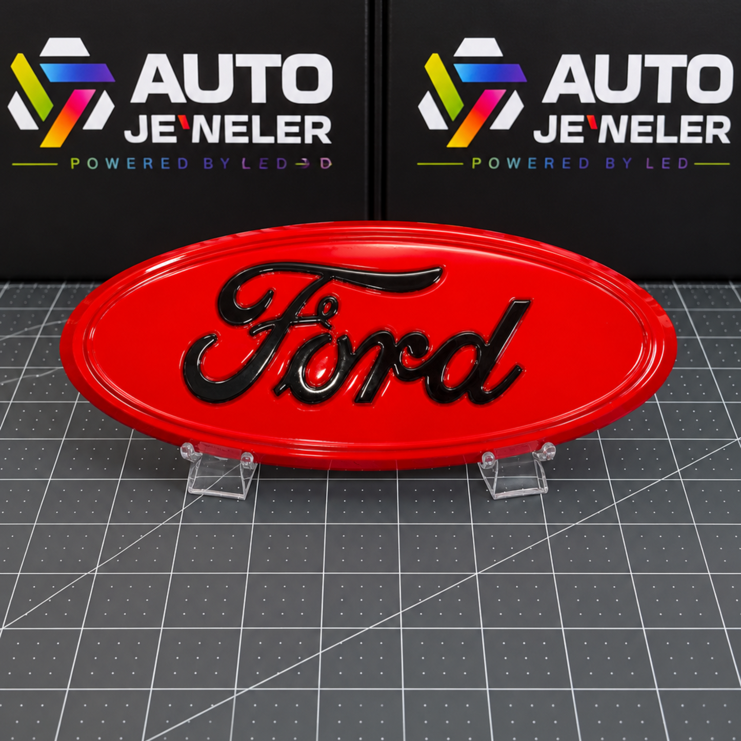 AutoJeweler Custom painted Race Red Ford 9-inch grille and tailgate emblem with gloss black Ford script shown with the LEDs off.