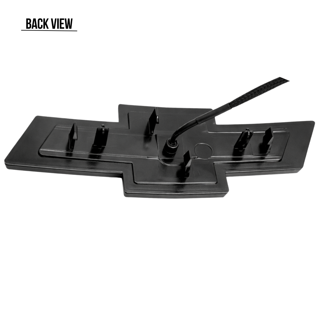 Back view of the all black LED Chevy bowtie grille emblem showing wiring connection and mounting tabs for 2016–2018 Silverado 1500