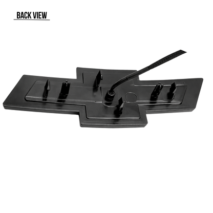Back view of the all black LED Chevy bowtie grille emblem showing wiring connection and mounting tabs for 2016–2018 Silverado 1500