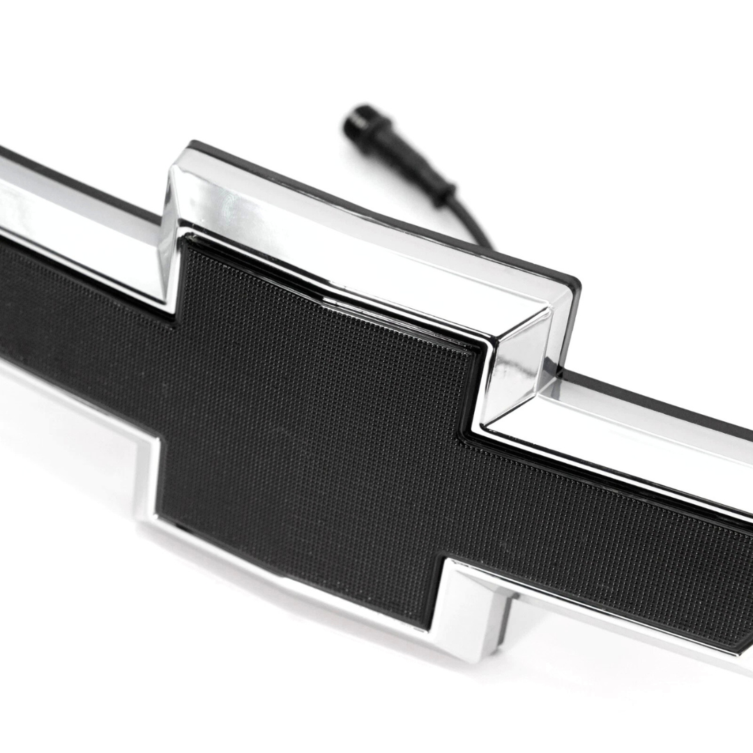 Close-up detail of chrome and black textured LED bowtie grille emblem for 2016–2018 Chevy Silverado 1500
