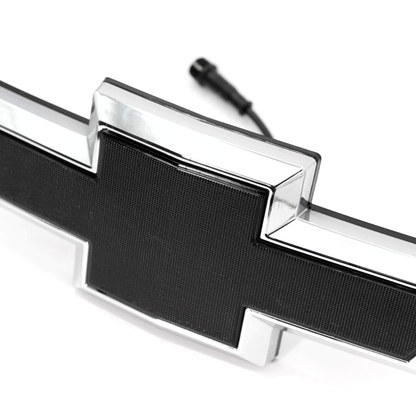 Close-up detail of chrome and black textured LED bowtie grille emblem for 2016–2018 Chevy Silverado 1500