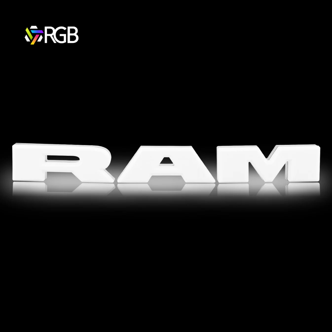 RAM 1500 black RGB LED grille emblem illuminated in white, glowing effect on black background, AutoJeweler RGB branding