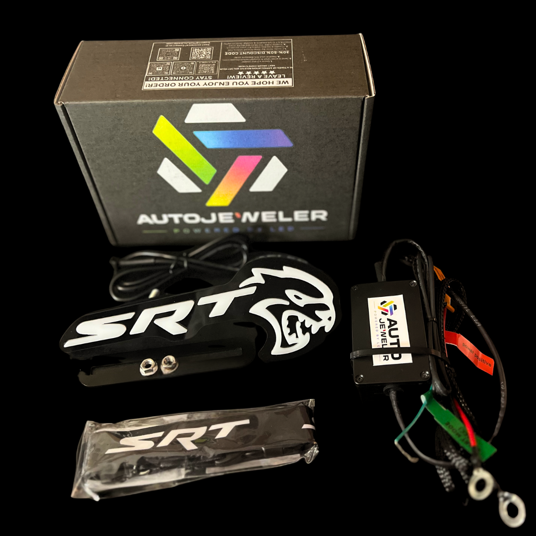 AutoJeweler Flow Series Hellcat Redeye-style LED grille emblem kit contents showing box, emblem, controller module, and wiring harness