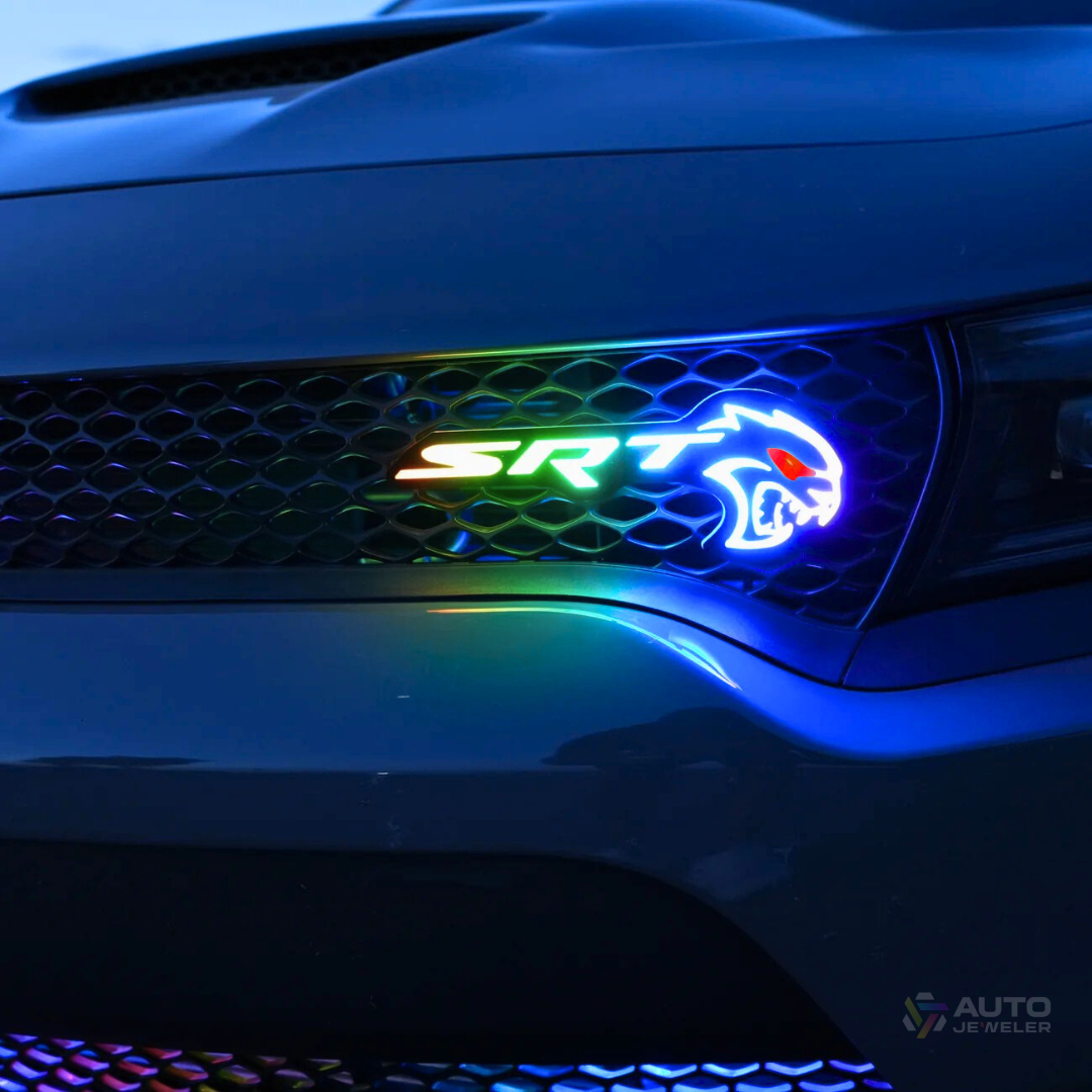Flow Series RGB LED Hellcat Redeye-style grille emblem installed on Dodge Charger grille showing multicolor color-chasing effect