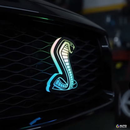AutoJeweler Flow Series RGBW Cobra LED grille emblem installed on Ford Mustang with flowing color lighting effect