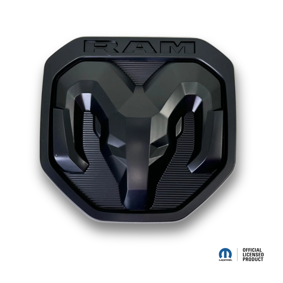 AutoJeweler RAM black tailgate emblem, power off, Black Edition on white background with Mopar Official Licensed Product badge
