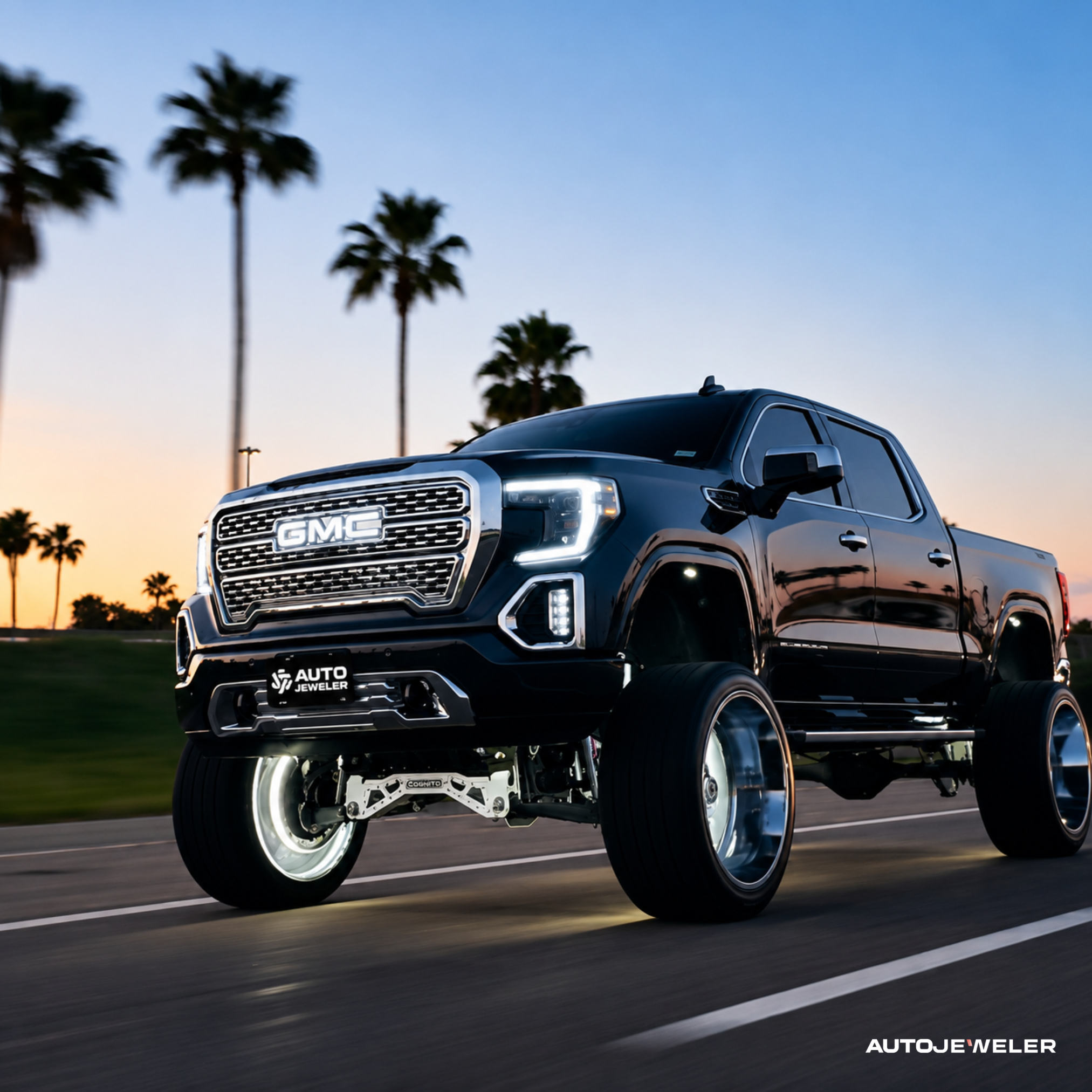 GMC Sierra truck with white RGBW LED illuminated grille logo installed for a clean OEM-style look.