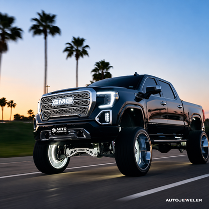 GMC Sierra truck with white RGBW LED illuminated grille logo installed for a clean OEM-style look.