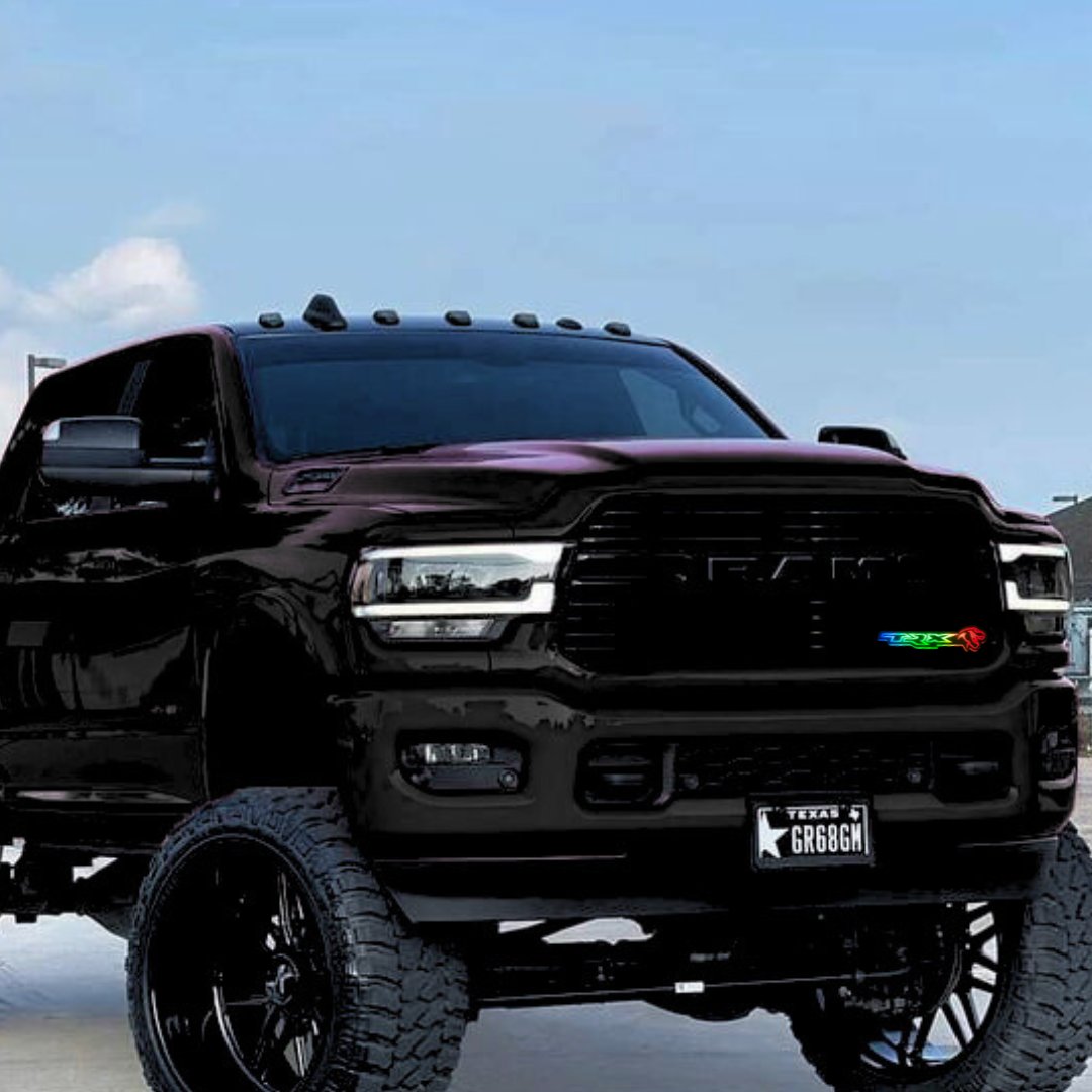 Black RAM 2500 truck with RGBW Flow Series grille emblem and Texas license plate, photographed in daylight against a clear blue sky.