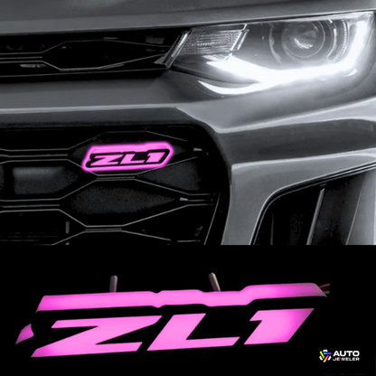 Chevy Camaro ZL1 with pink RGBW Flow Series LED grille emblem by AutoJeweler, night view close-up