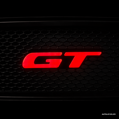 Red 'GT' logo on a black honeycomb grille for a Ford Mustang GT by AutoJeweler.