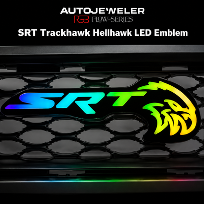 AutoJeweler SRT Trackhawk Hellhawk RGB Flow Series LED grille emblem with multicolor illuminated lighting effects mounted on honeycomb grille background