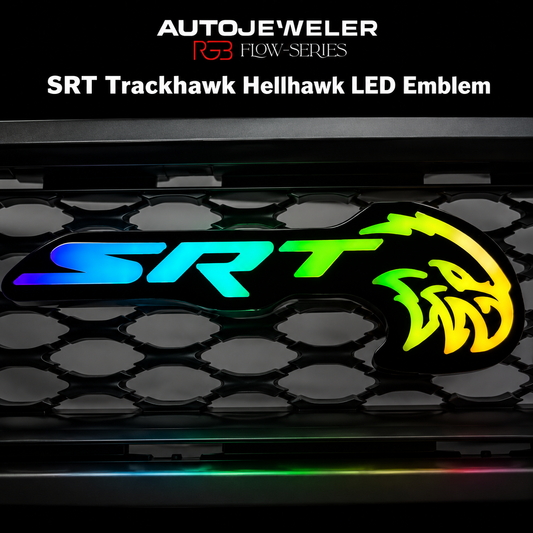 AutoJeweler SRT Trackhawk Hellhawk RGB Flow Series LED grille emblem with multicolor illuminated lighting effects mounted on honeycomb grille background