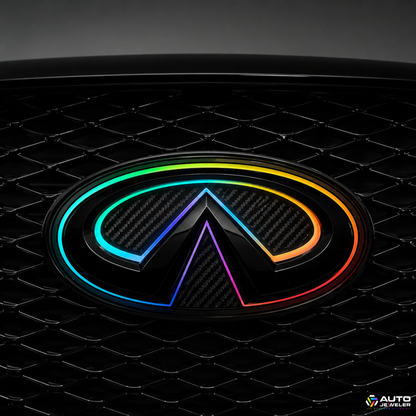 Close-up of the AutoJeweler 2018–2024 Infiniti Q50 V2 Multicolor Flow Series LED grille emblem featuring a gloss black housing, carbon fiber face, and animated RGB Flow lighting installed in the factory grille.