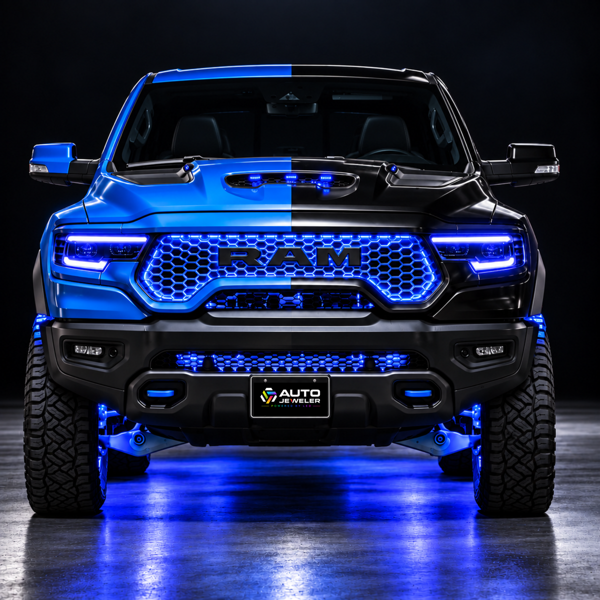 RAM truck front end with AutoJeweler Flow Series RGB grille lighting illuminated in blue across the upper and lower grille, with matching blue accent lighting.