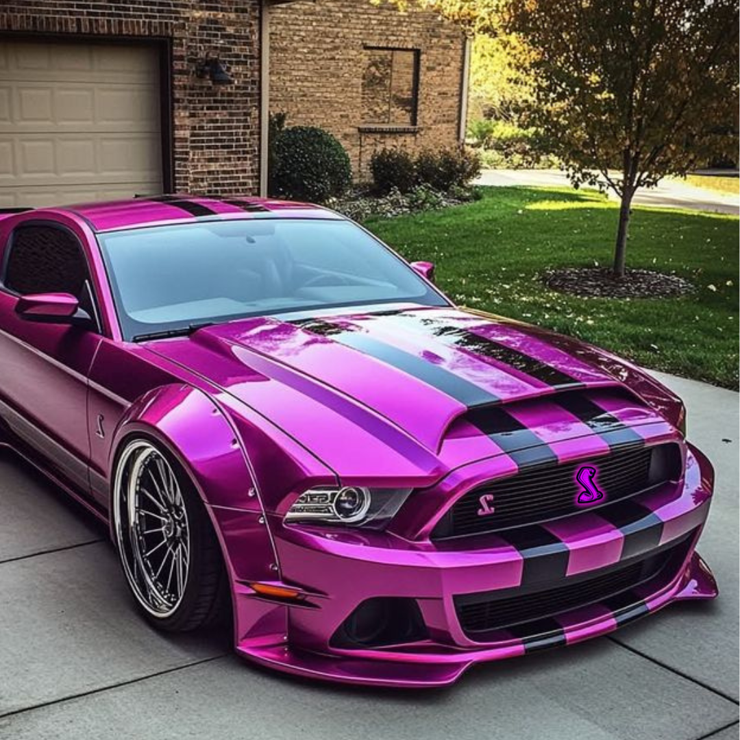 Pink custom Ford Mustang with RGBW Cobra grille emblem glowing in purple, installed in front driveway