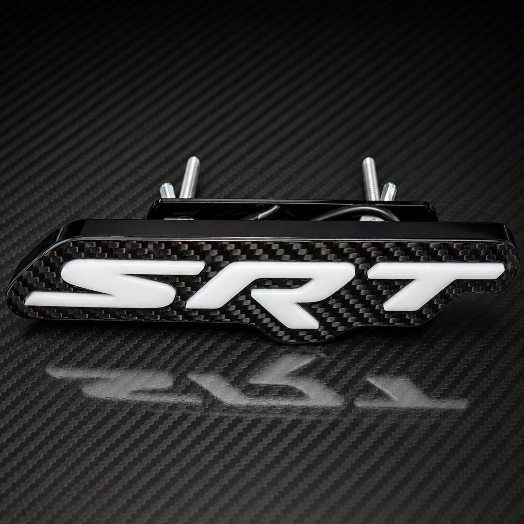 An LED  carbon fiber SRT badge with white 3D lettering, on a matching carbon fiber background.