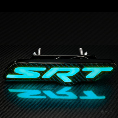 AutoJeweler Custom flow series carbon fiber SRT LED grille emblem glowing blue on a carbon fiber background