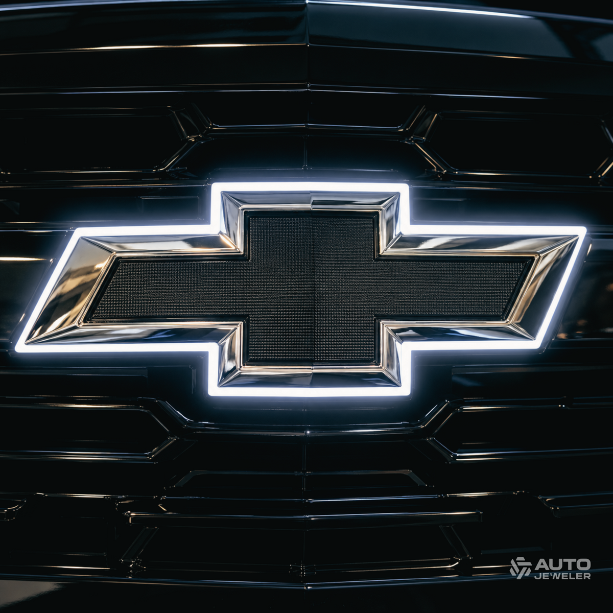 Chrome and black white LED illuminated Chevrolet bowtie shown mounted on a black vehicle grille