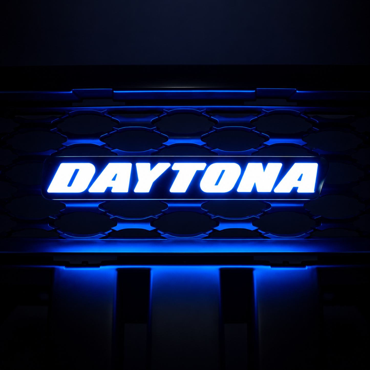 Daytona LED grille emblem illuminated in bright blue lighting mode with gloss black housing and grille background