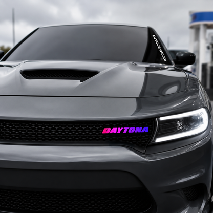 Gray Dodge Charger featuring Daytona RGB LED grille emblem with pink and purple gradient lighting installed on front grille