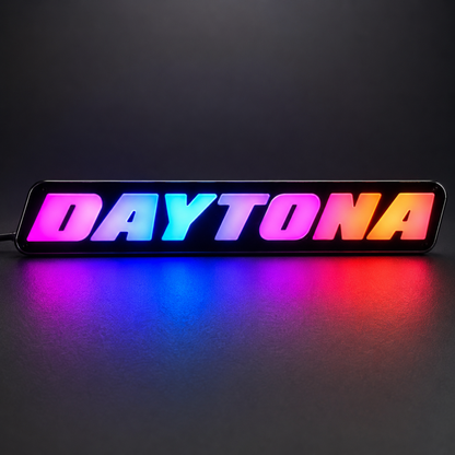 AutoJeweler Daytona RGB LED grille emblem with vibrant gradient lighting colors including pink blue orange and purple
