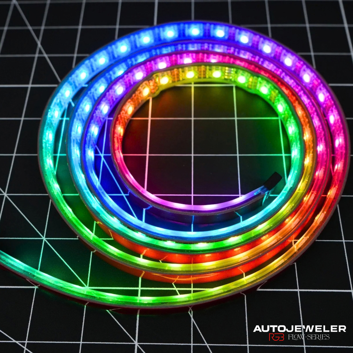 AutoJeweler Flow Series RGB LED light strip displaying a multicolor rainbow flowing effect for custom grille lighting and automotive accent lighting.