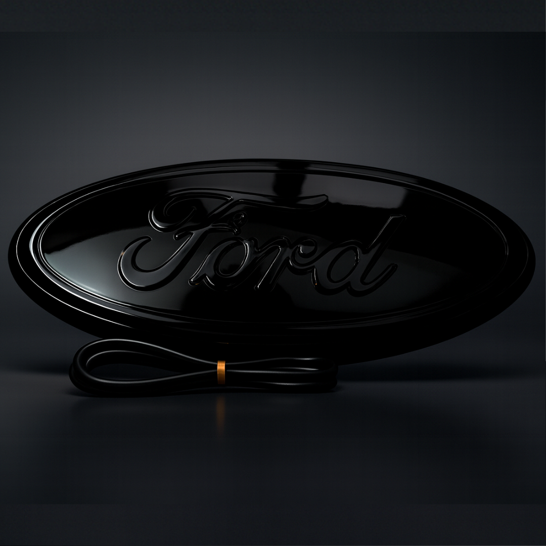 Gloss black Ford 9-inch emblem, power off, studio hero shot with subtle reflection
