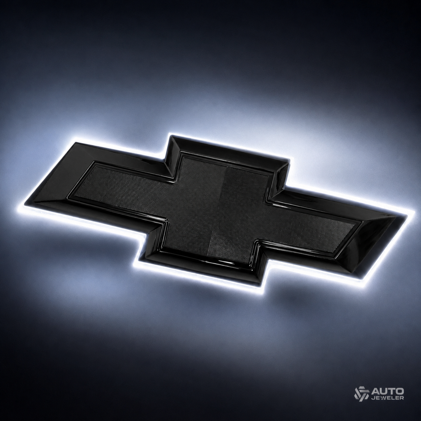 AutoJeweler gloss black Chevy bowtie emblem glowing with pure white back-lit halo illumination.