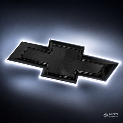 AutoJeweler gloss black Chevy bowtie emblem glowing with pure white back-lit halo illumination.