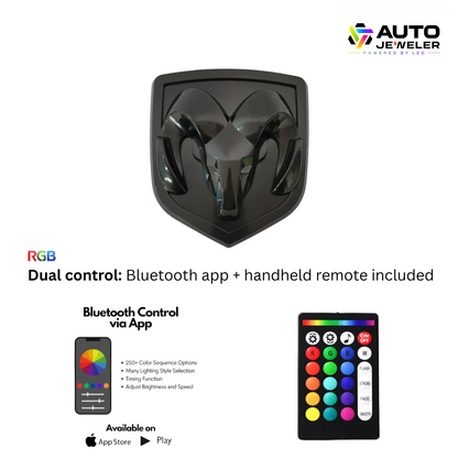 AutoJeweler black LED grille emblem for RAM 1500 with dual control—Bluetooth app and handheld remote included, RGB color-changing lighting.