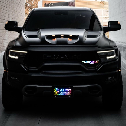 RGB Flow Series TRX LED grille badge installed on the front grille of a RAM TRX truck