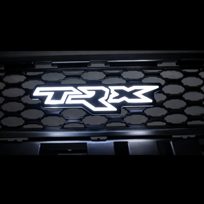 TRX LED grille badge illuminated in solid white mounted on RAM TRX grille