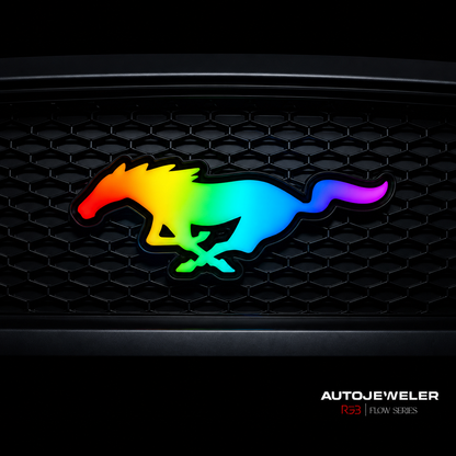 AutoJeweler RGB Flow Series LED Mustang grille emblem with multicolor lighting on black honeycomb grille, dynamic chasing LED pattern aftermarket badge