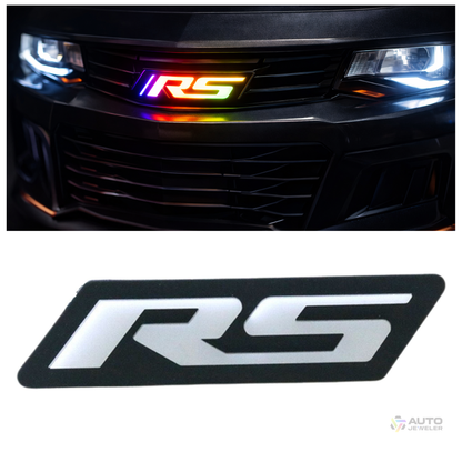 AutoJeweler RS Flow Series RGB LED emblem installed in vehicle grille with multicolor lighting and the original RS emblem not lit up