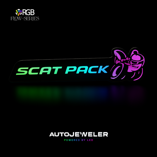 Scat Pack RGB Flow-Series LED grille emblem glowing in multicolor on a black background – AutoJeweler hero image