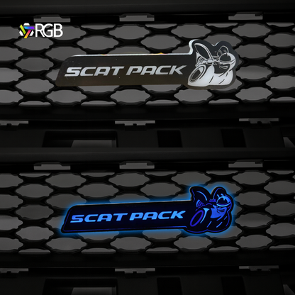 Side-by-side comparison of Scat Pack RGB Flow-Series LED grille emblem on a honeycomb grille—top unlit, bottom illuminated in blue—AutoJeweler.